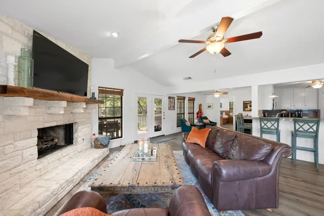a living room with furniture a fireplace and a flat screen tv