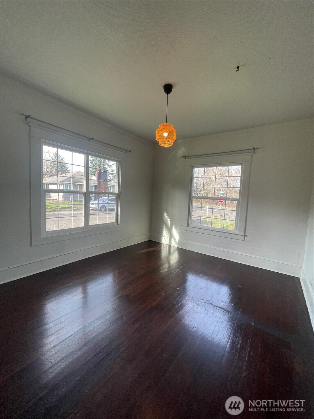 2101 Henkle Street Raymond, WA 98577 - Photo 12 of 18 an empty room with wooden floor and windows