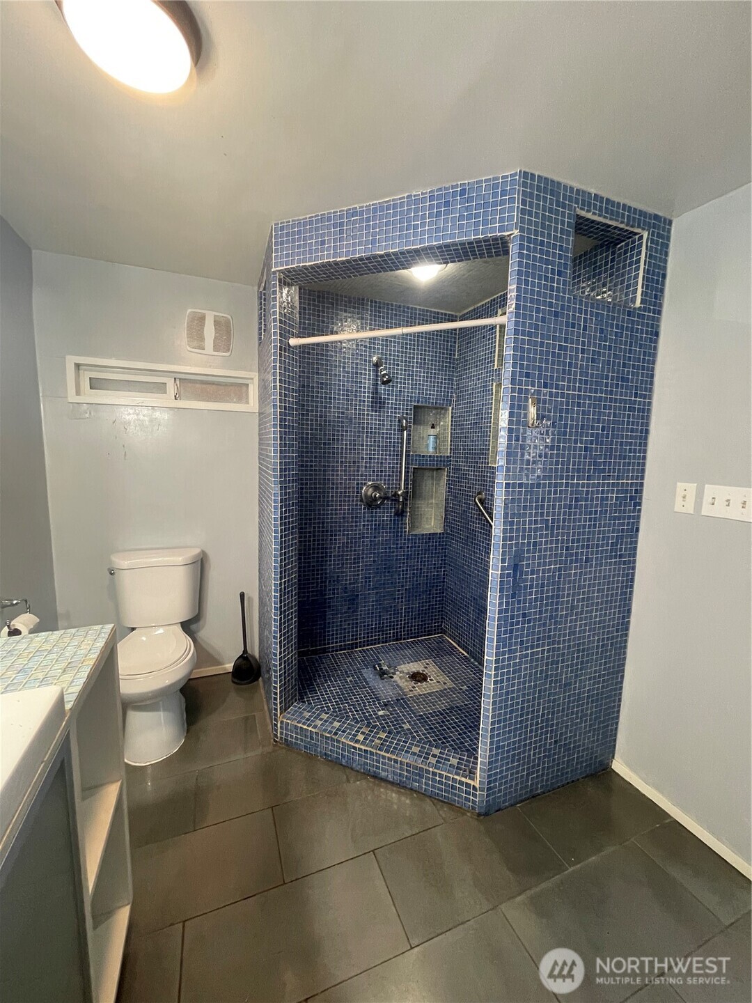 2101 Henkle Street Raymond, WA 98577 - Photo 17 of 18 a bathroom with a granite countertop shower and a toilet