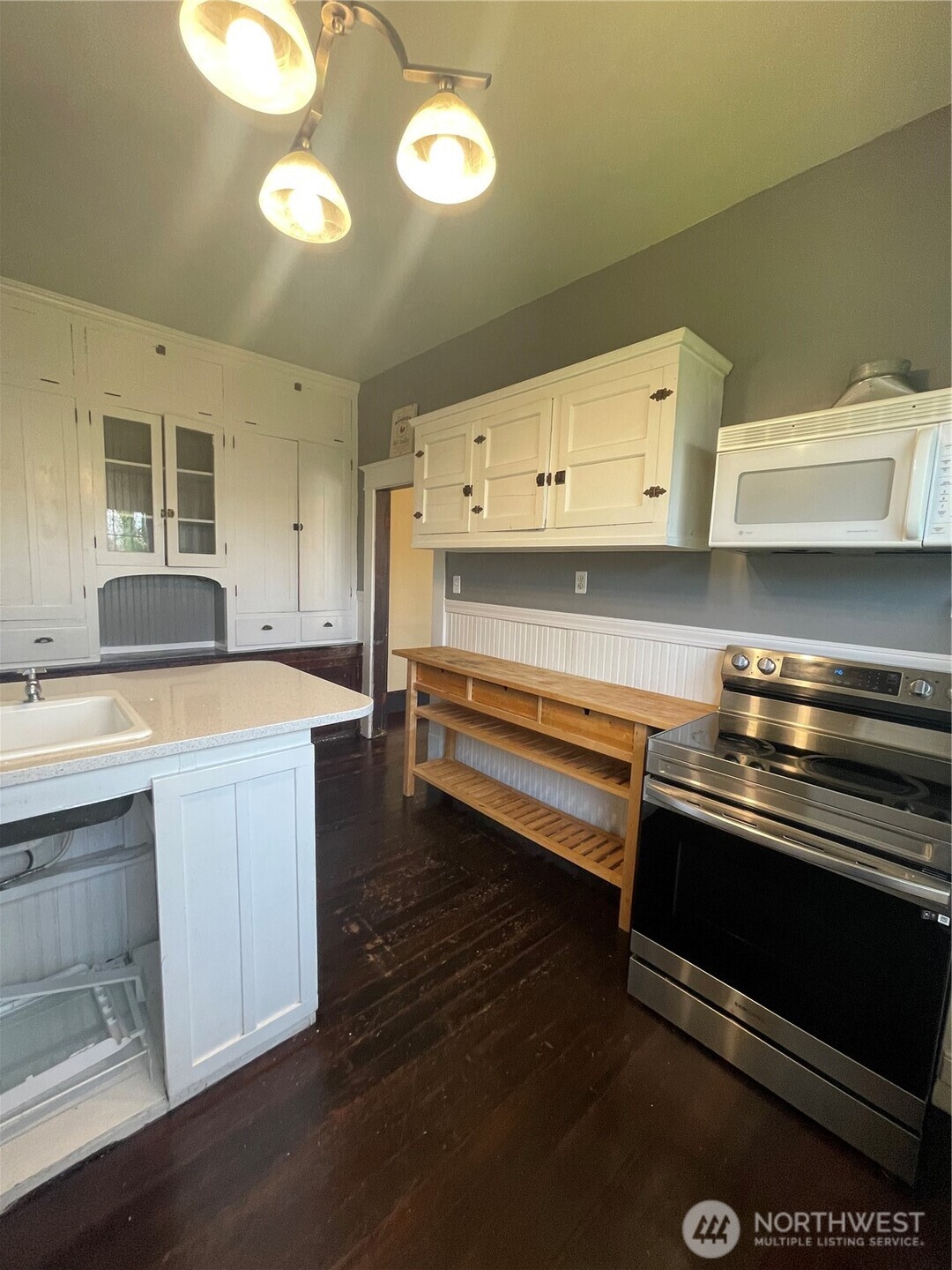 2101 Henkle Street Raymond, WA 98577 - Photo 7 of 18 a kitchen with wooden cabinets and a stove