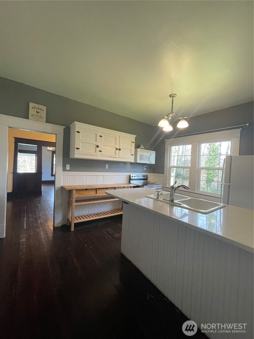 2101 Henkle Street Raymond, WA 98577 - Photo 9 of 18 a kitchen with kitchen island granite countertop a sink cabinets and wooden floor