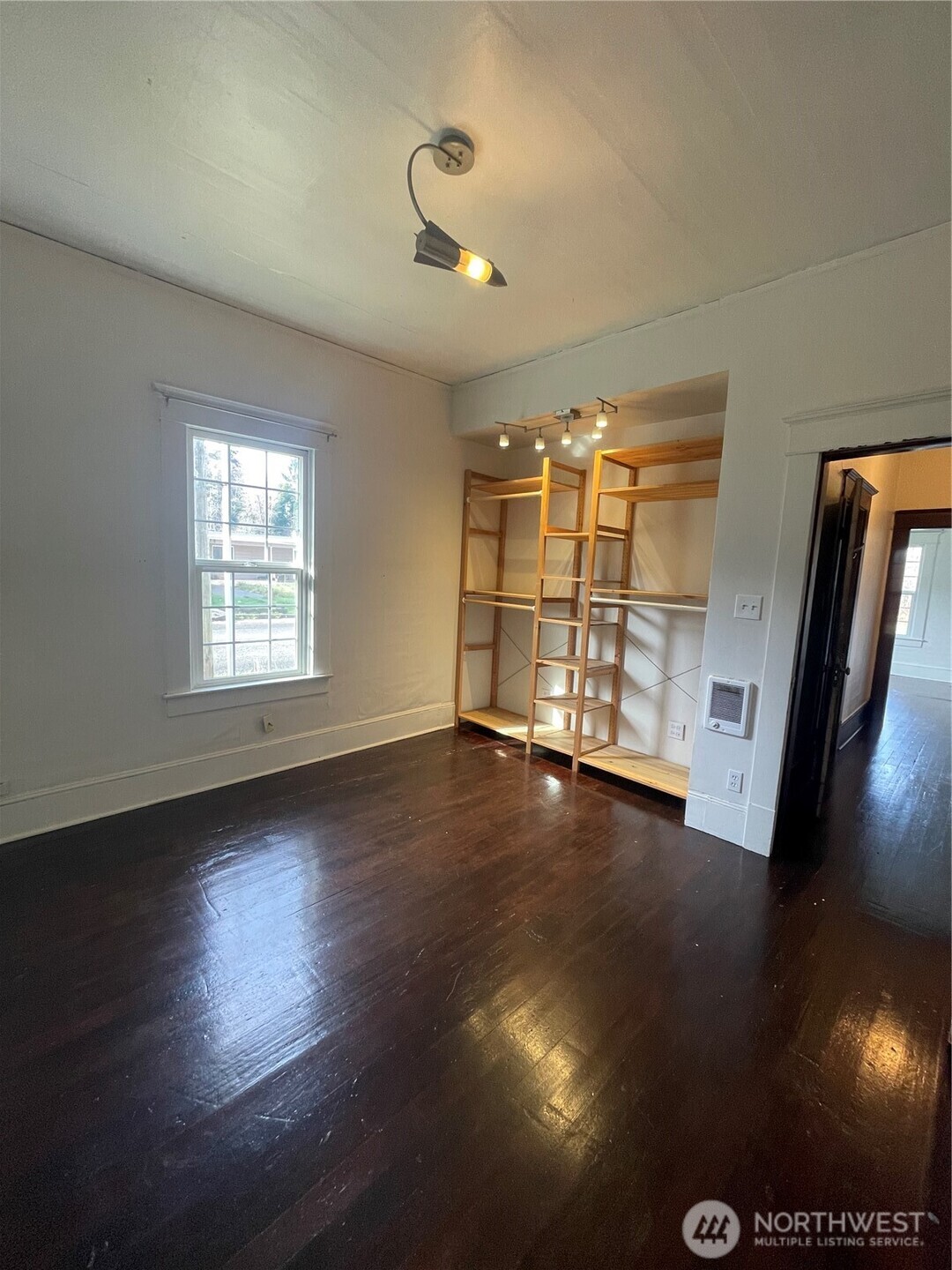2101 Henkle Street Raymond, WA 98577 - Photo 10 of 18 an empty room with wooden floor and windows