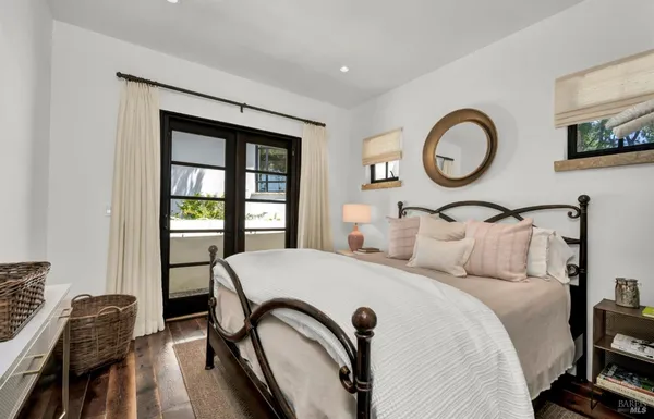 a bedroom with a bed and glass windows