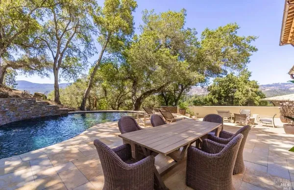 a view of backyard with seating space and trees