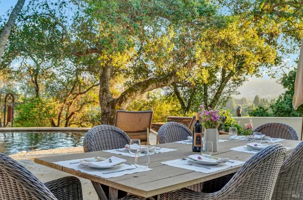 a living room with fireplace furniture chandelier and a large window