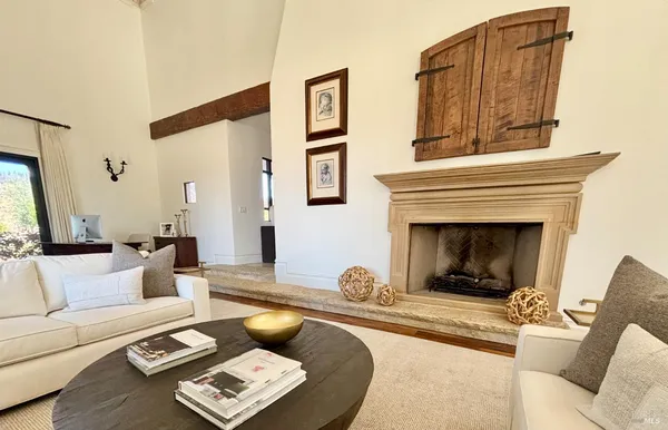 a kitchen with stainless steel appliances a dining table and chairs
