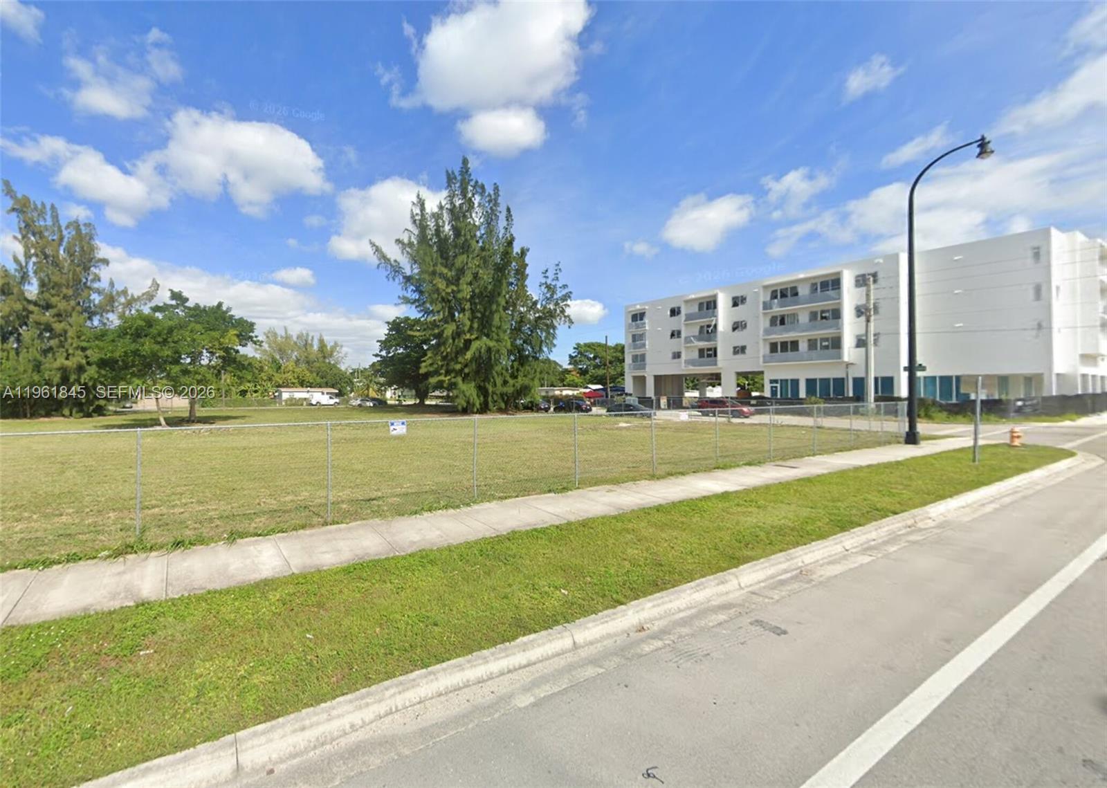 0 216th Street Miami, FL 33177 - Photo 1 of 1 a view of a building with a big yard and a large trees