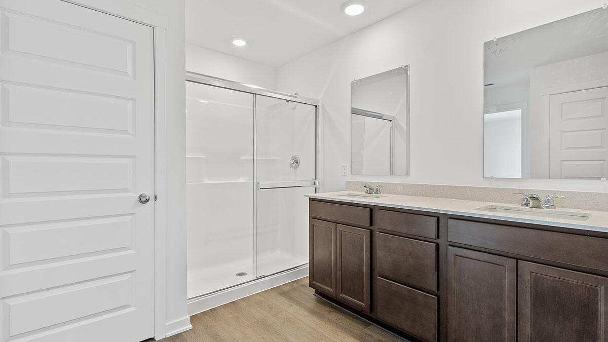 444 Fry Street Hebron, IN 46341 - Photo 13 of 25 a bathroom with a double vanity sink and a mirror