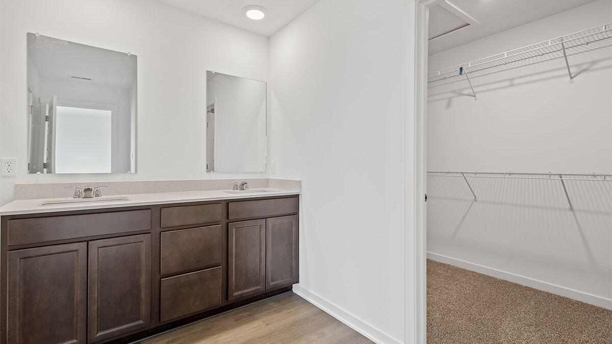 444 Fry Street Hebron, IN 46341 - Photo 14 of 25 a bathroom with a double vanity sink and a mirror