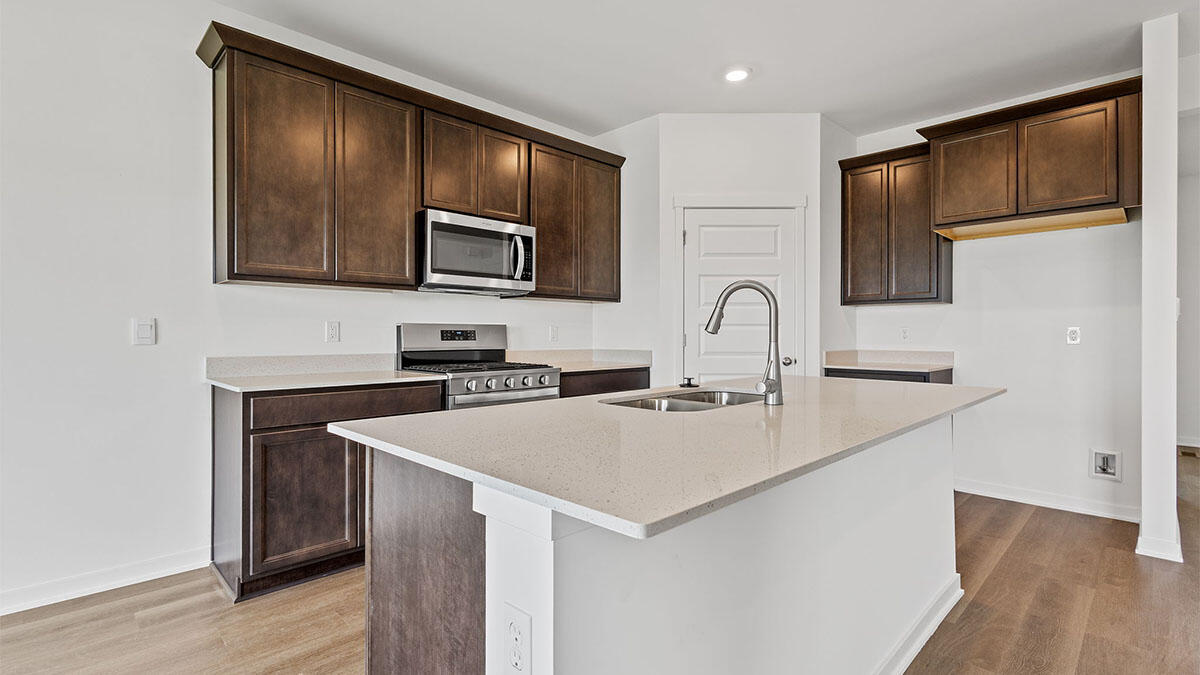 444 Fry Street Hebron, IN 46341 - Photo 3 of 25 a kitchen with stainless steel appliances a stove microwave and sink