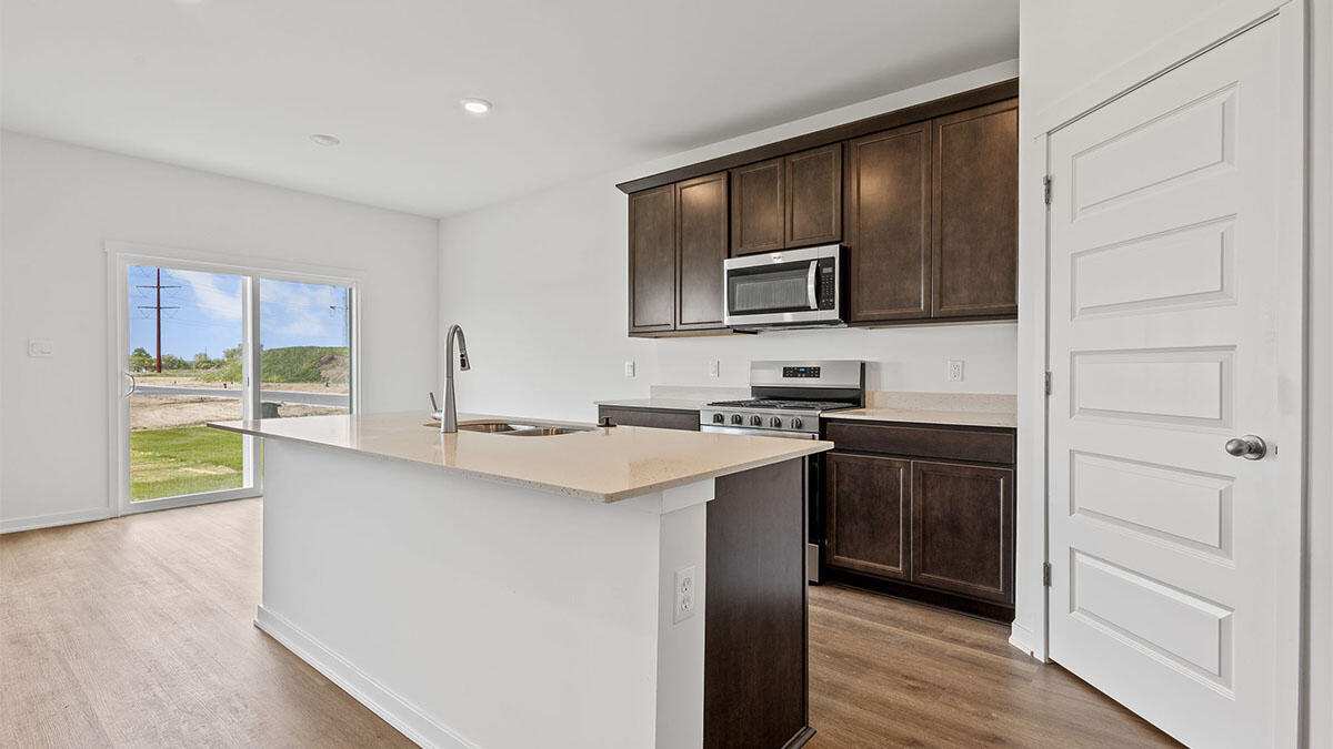 444 Fry Street Hebron, IN 46341 - Photo 4 of 25 a kitchen with stainless steel appliances a sink stove and cabinets