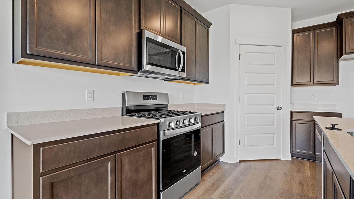 444 Fry Street Hebron, IN 46341 - Photo 5 of 25 a kitchen with stainless steel appliances a stove microwave and refrigerator