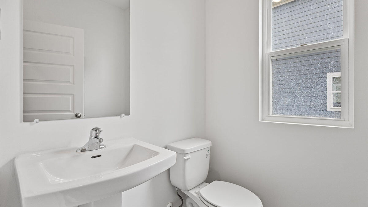 444 Fry Street Hebron, IN 46341 - Photo 9 of 25 a white toilet sitting next to a bathroom sink