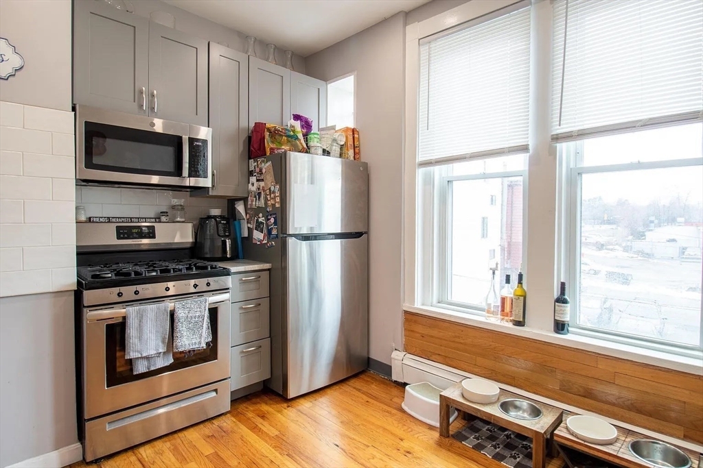 117 Elm Street, Unit 2 Newton, MA 02465 - Photo 2 of 10 a kitchen with stainless steel appliances a stove microwave and refrigerator
