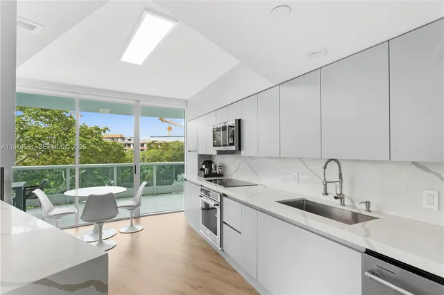 a kitchen with a sink appliances and cabinets