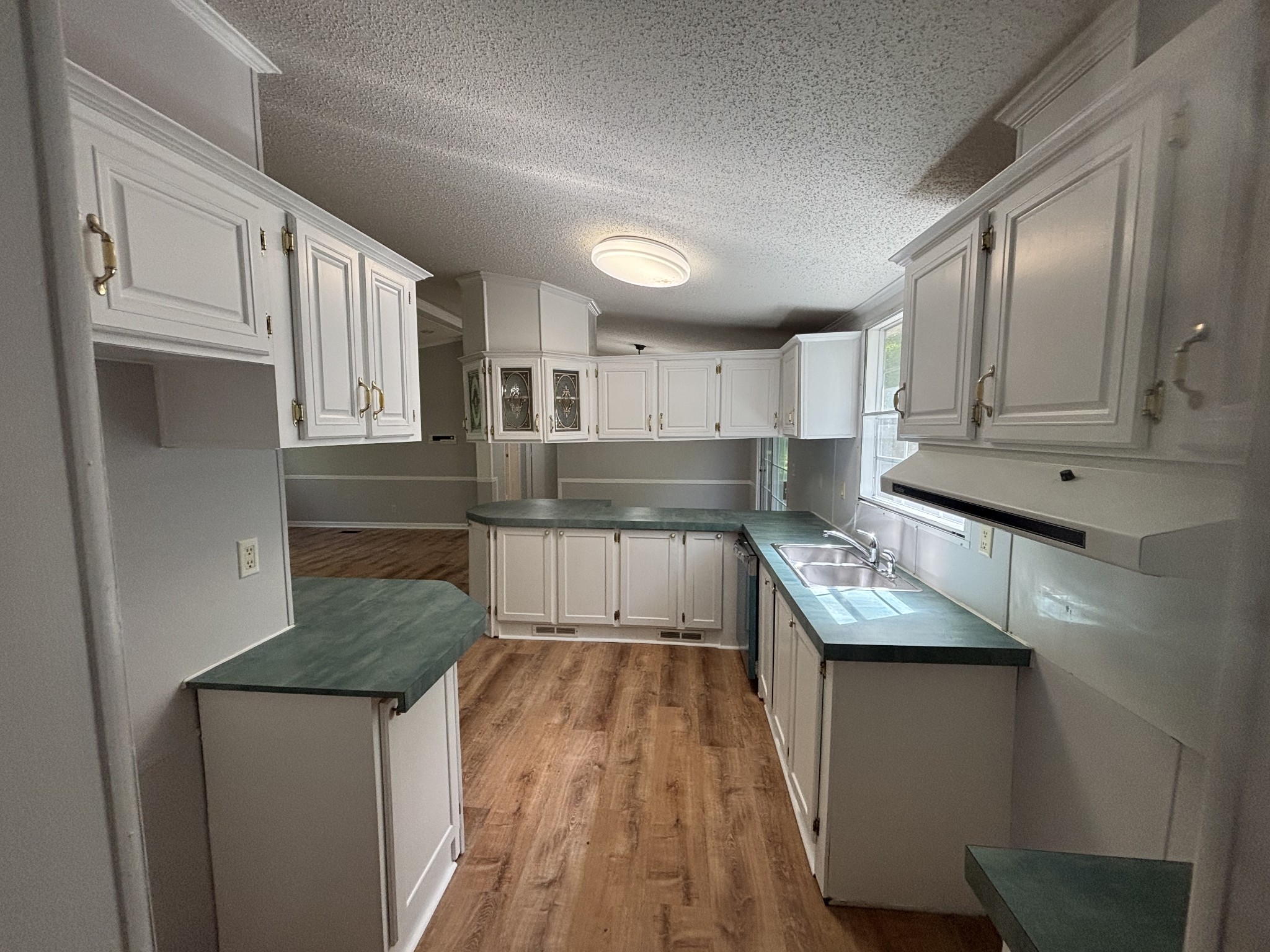 3329 Tackets Branch Road Prospect, TN 38477 - Photo 15 of 24 a kitchen with granite countertop a sink a counter top space stainless steel appliances and cabinets
