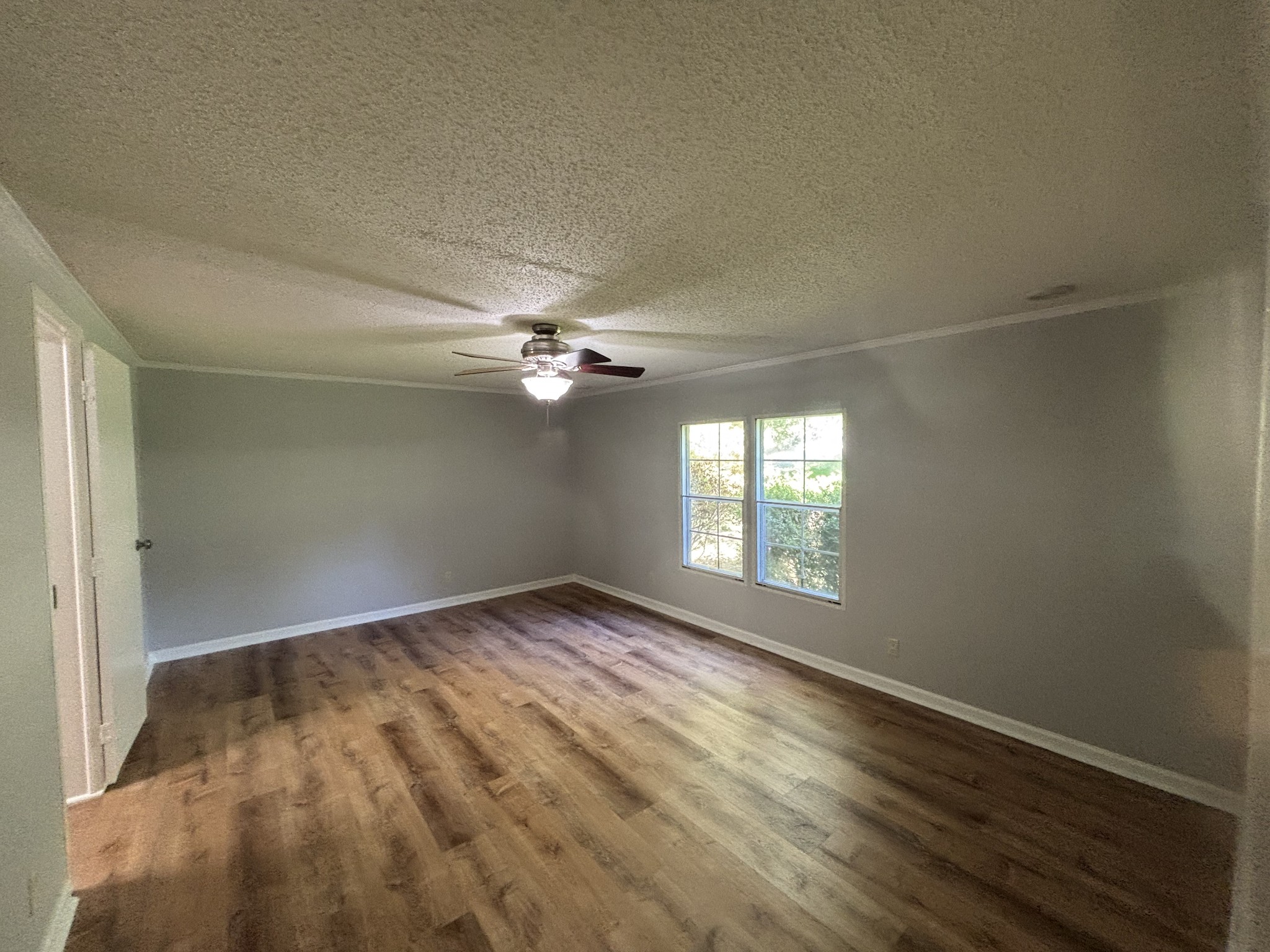 3329 Tackets Branch Road Prospect, TN 38477 - Photo 16 of 24 a view of empty room with wooden floor and fan