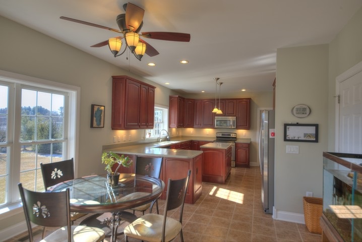 53 Old White Bridge Road Waynesboro, VA 22980 - Photo 16 of 49 a dining room with stainless steel appliances kitchen island granite countertop a table chairs and a microwave