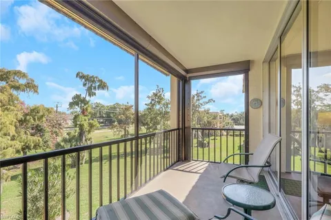 a view of a balcony with chair and a potted plant