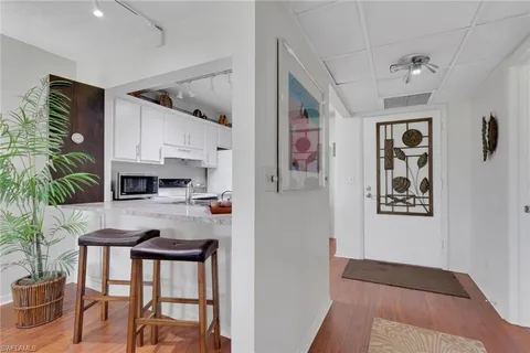 a kitchen with stainless steel appliances granite countertop a refrigerator and a stove
