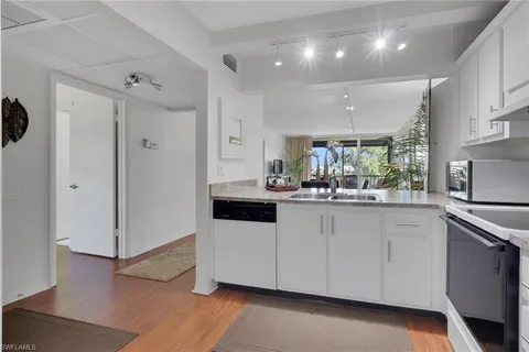 a kitchen with stainless steel appliances a sink and refrigerator