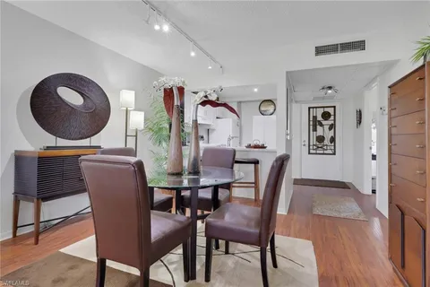 a dining room with furniture and wooden floor