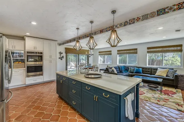 a kitchen with a sink and appliances
