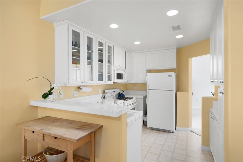733 Cottage Lane Paso Robles, CA 93446 - Photo 12 of 47 a kitchen with a refrigerator a sink and a refrigerator