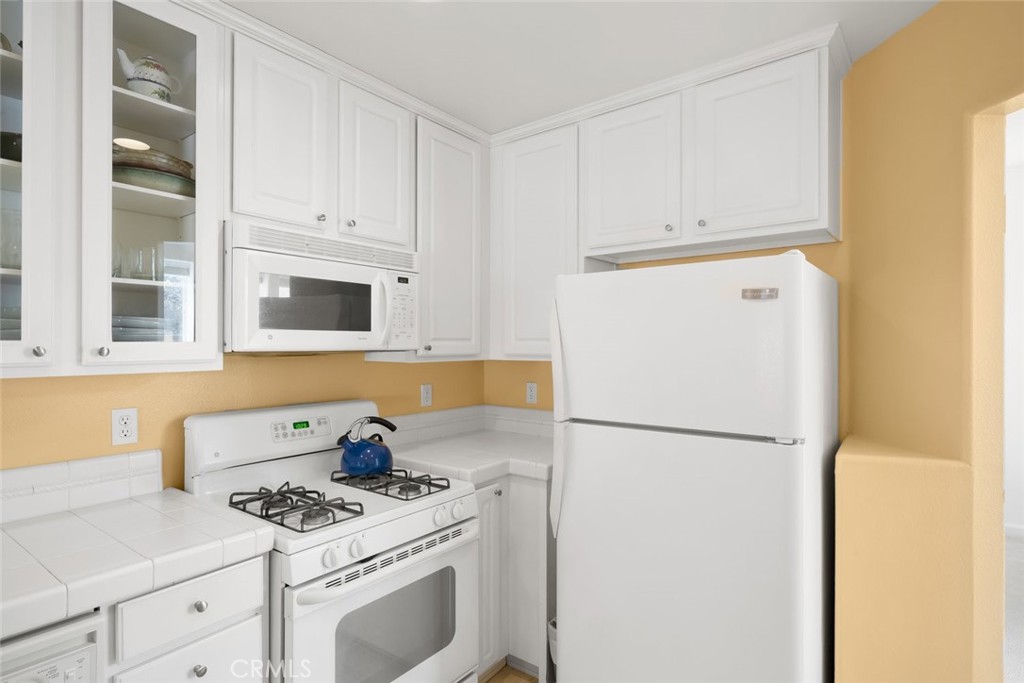 733 Cottage Lane Paso Robles, CA 93446 - Photo 13 of 47 a kitchen with stainless steel appliances white cabinets and a refrigerator