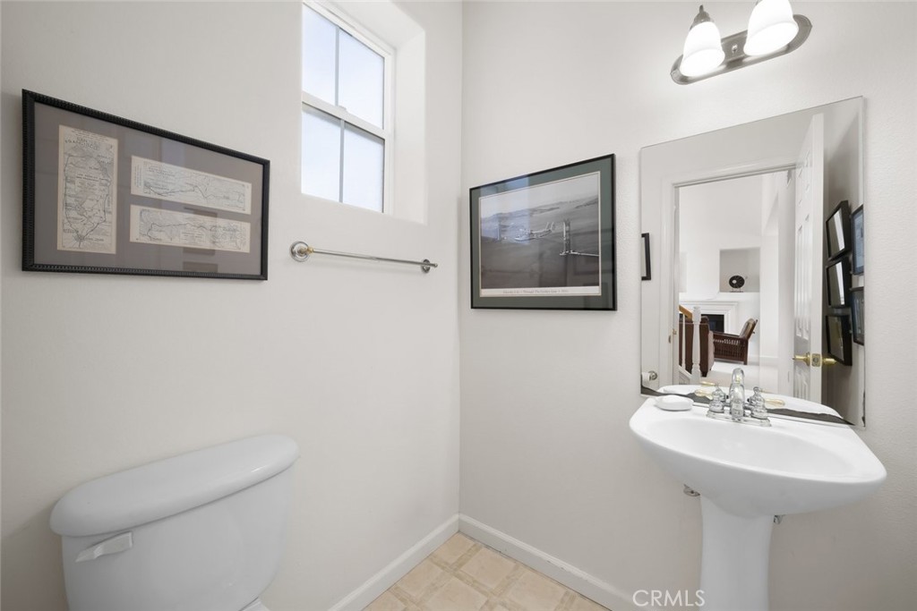 733 Cottage Lane Paso Robles, CA 93446 - Photo 29 of 47 a bathroom with a toilet a sink and mirror