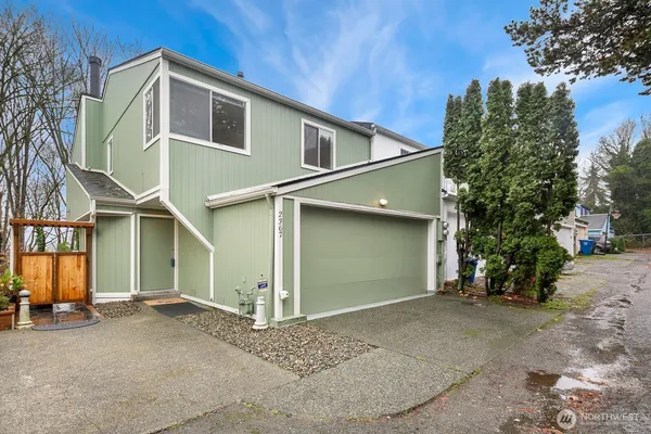a view of a house with a yard and garage