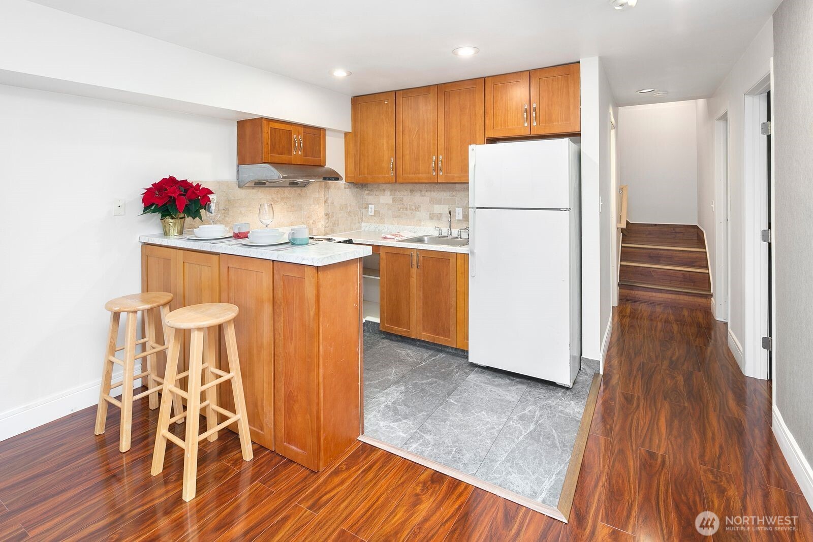 2367 South Forest Street Seattle, WA 98144 - Photo 18 of 33 a kitchen with granite countertop wooden floors and white stainless steel appliances