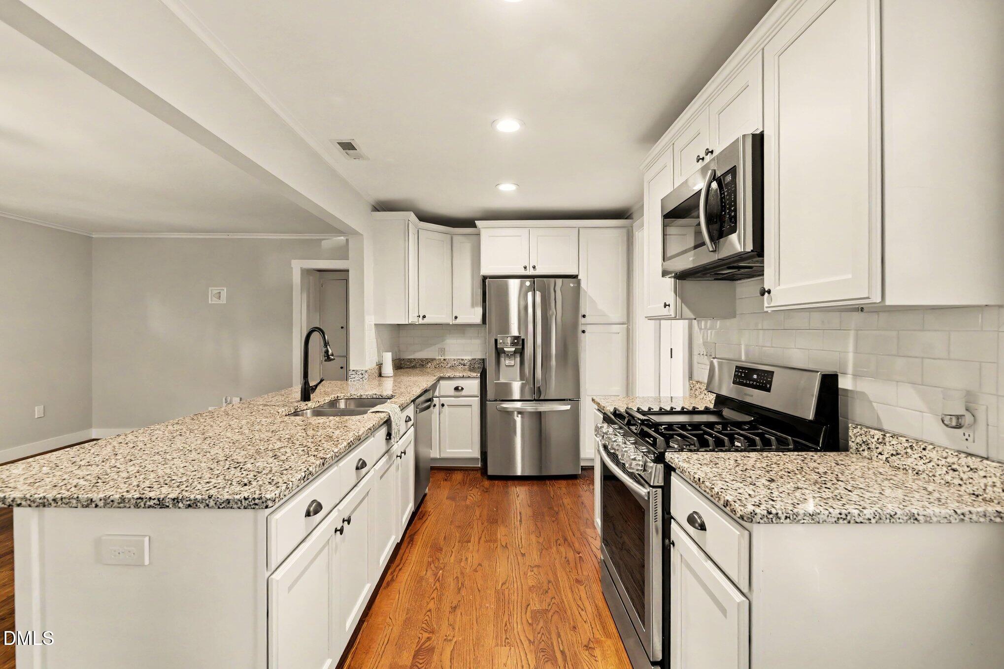 2111 Milburnie Road Raleigh, NC 27610 - Photo 7 of 27 Kitchen with recessed lighting and stainless steel appliances and breatfast nook