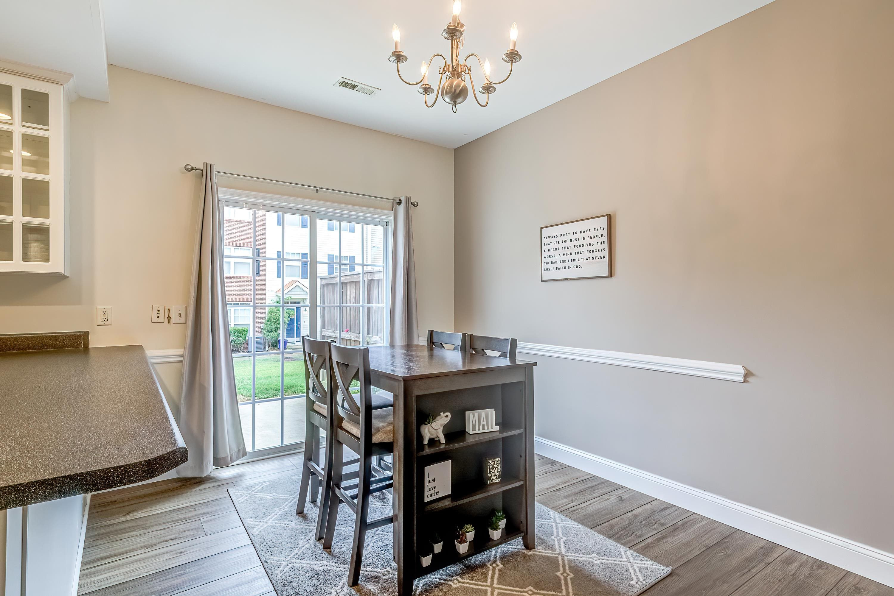 2131 Piney Brook Road, Unit 104 Raleigh, NC 27614 - Photo 12 of 37 a view of a dining room with furniture window and wooden floor