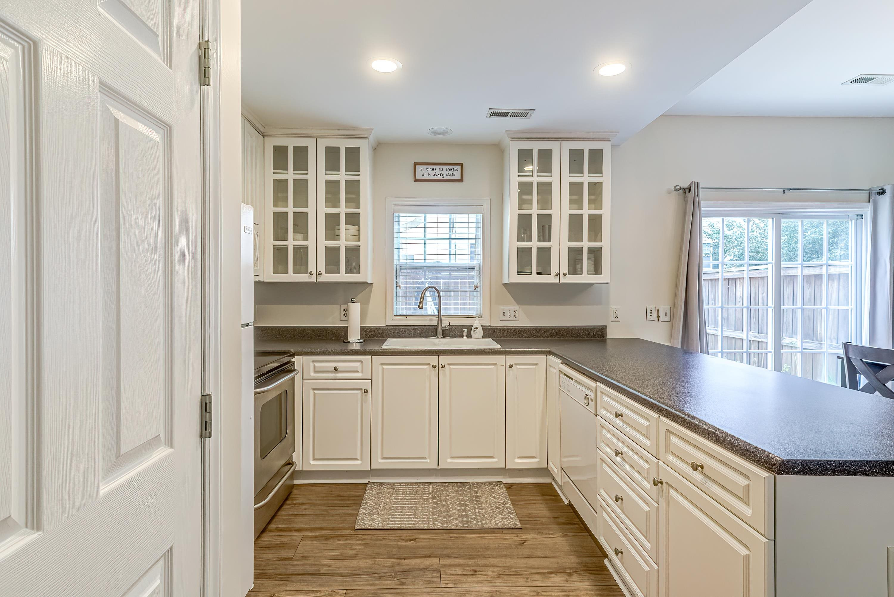 2131 Piney Brook Road, Unit 104 Raleigh, NC 27614 - Photo 16 of 37 a kitchen with granite countertop a sink stove and cabinets