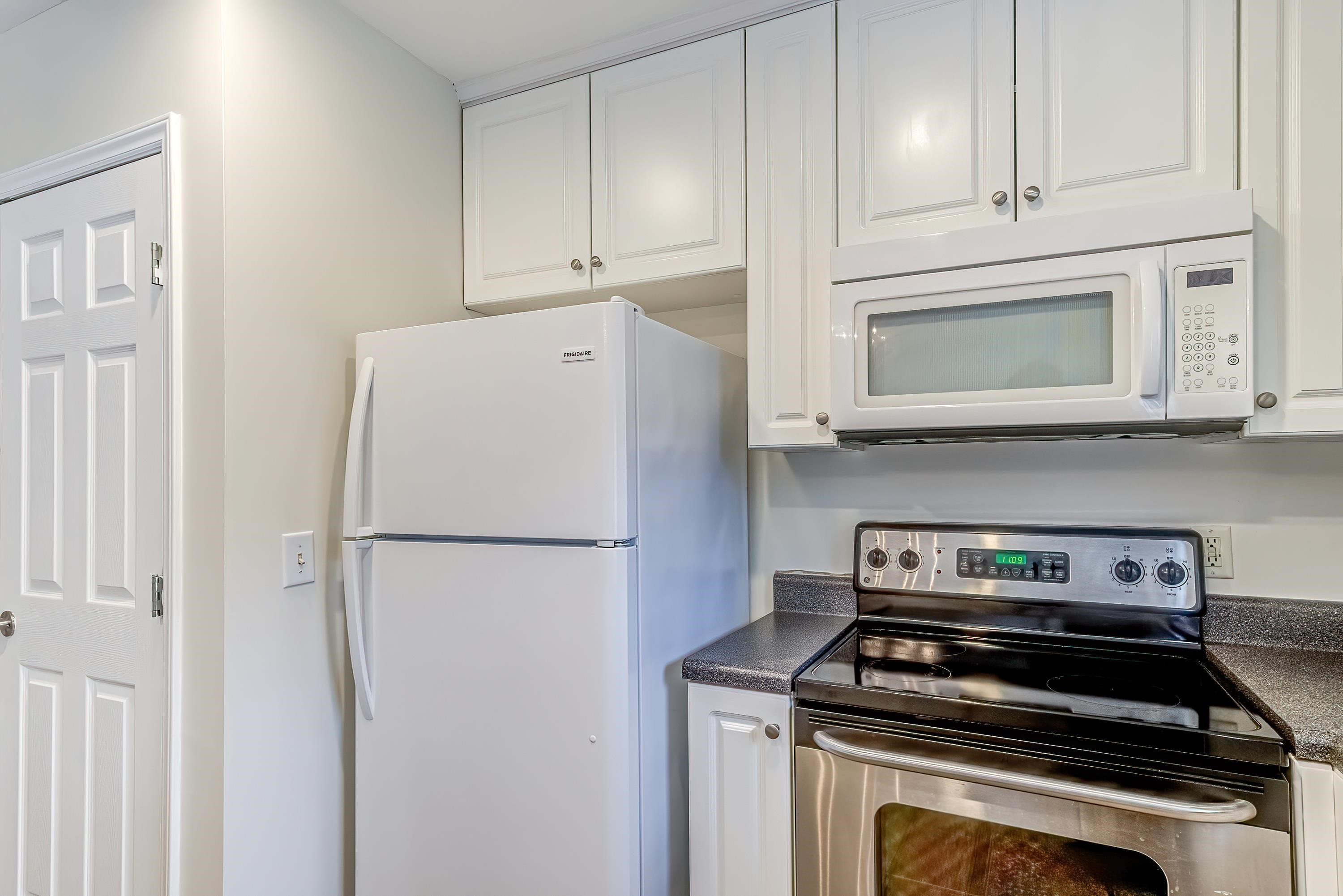 2131 Piney Brook Road, Unit 104 Raleigh, NC 27614 - Photo 19 of 37 a white refrigerator freezer and a stove sitting inside of a kitchen