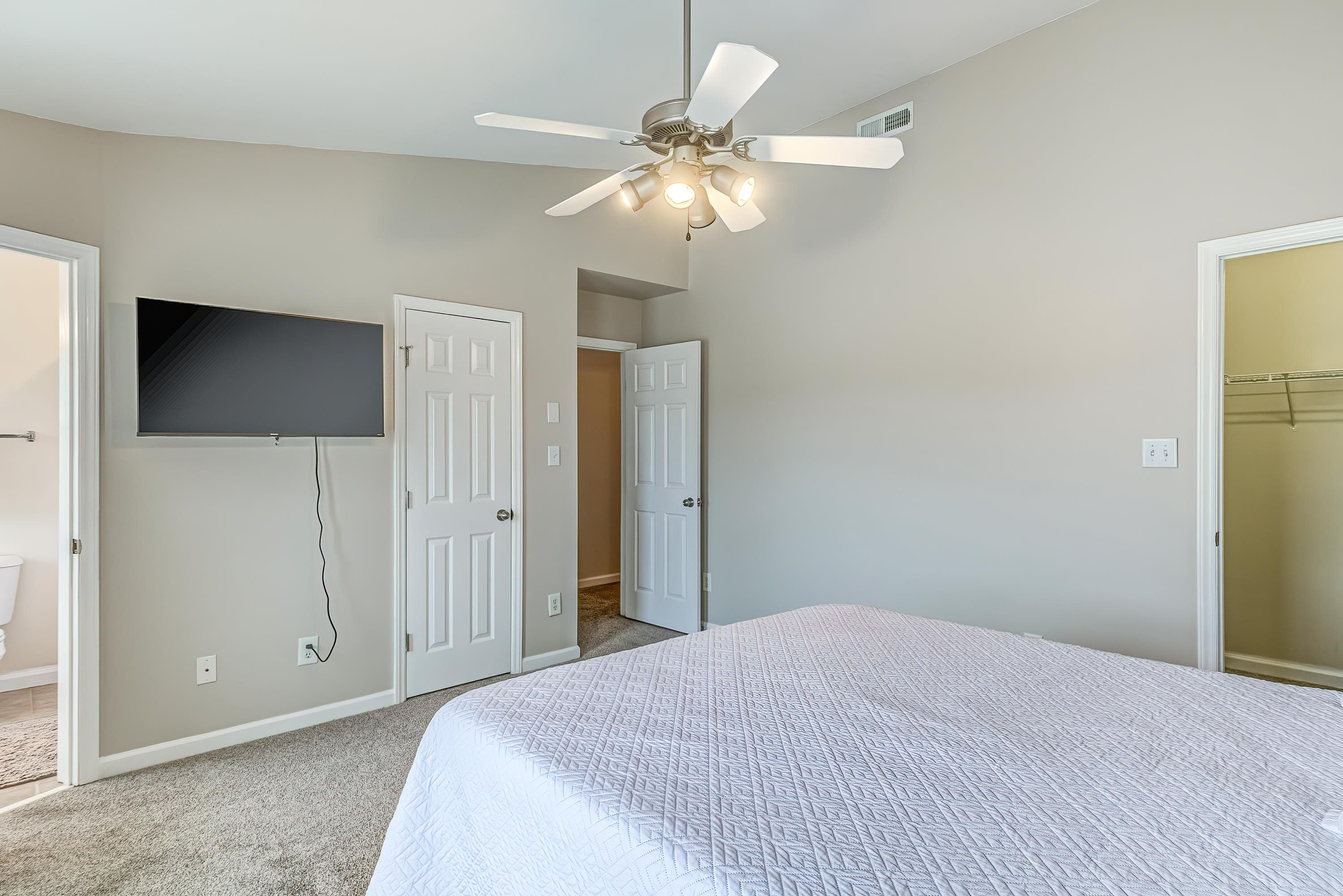 2131 Piney Brook Road, Unit 104 Raleigh, NC 27614 - Photo 22 of 37 a bedroom with a bed and a chandelier