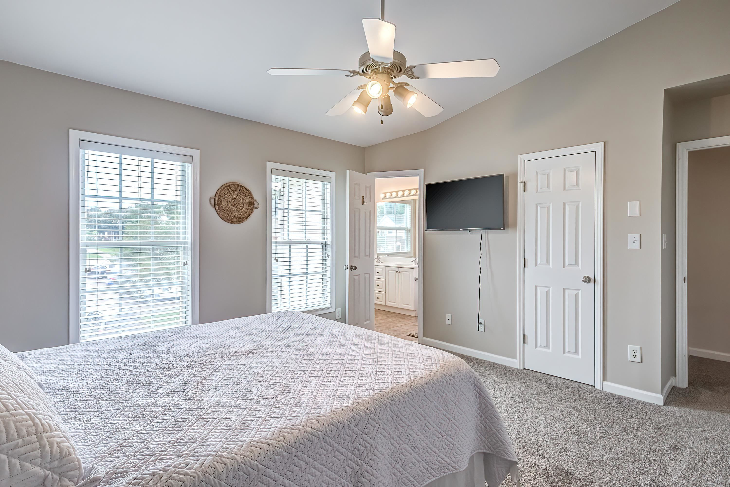 2131 Piney Brook Road, Unit 104 Raleigh, NC 27614 - Photo 23 of 37 a bedroom with a large bed and a chandelier