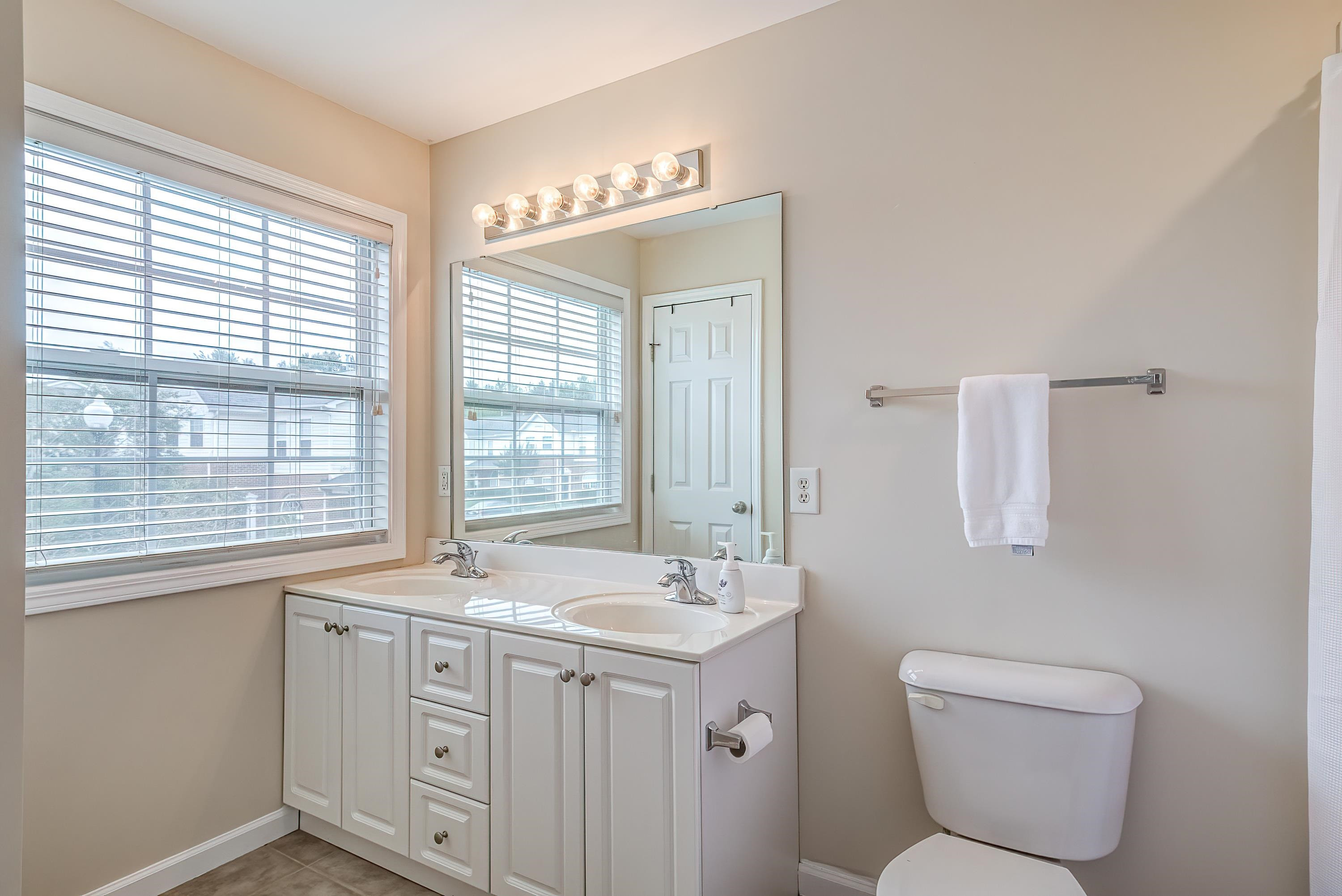 2131 Piney Brook Road, Unit 104 Raleigh, NC 27614 - Photo 25 of 37 a bathroom with a toilet sink and mirror
