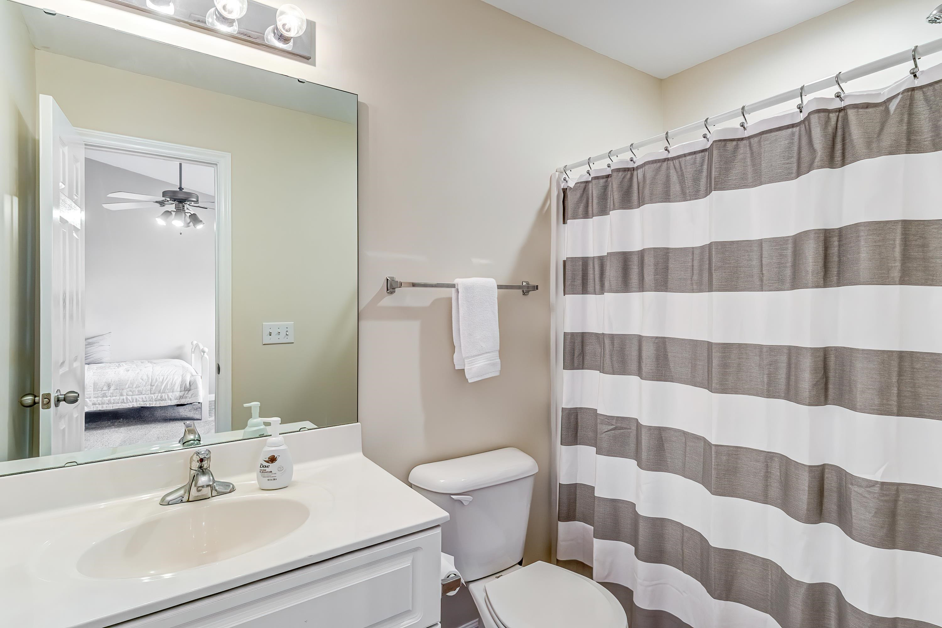 2131 Piney Brook Road, Unit 104 Raleigh, NC 27614 - Photo 29 of 37 a bathroom with a sink a toilet a mirror and shower