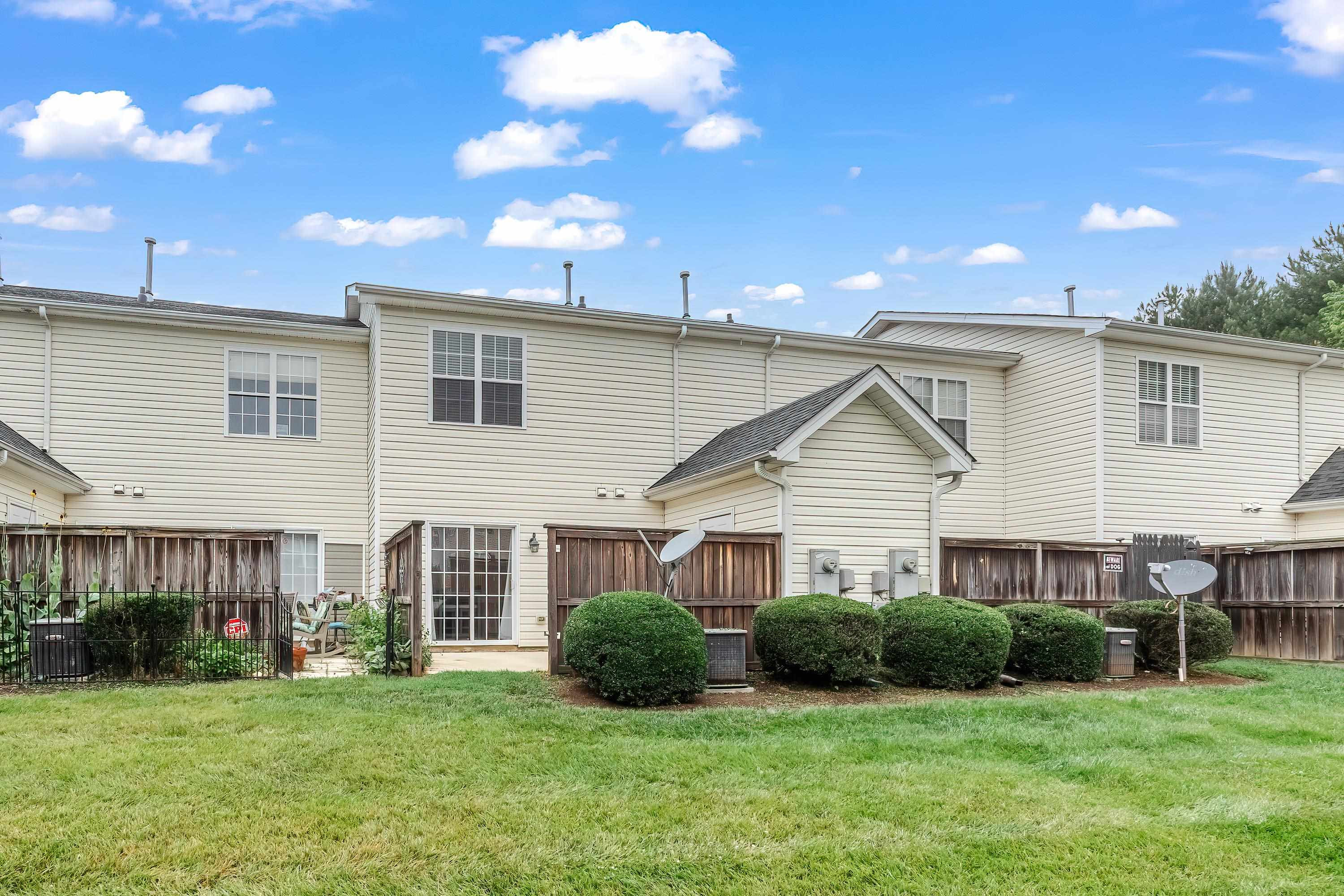 2131 Piney Brook Road, Unit 104 Raleigh, NC 27614 - Photo 31 of 37 a front view of a house with a yard and garage