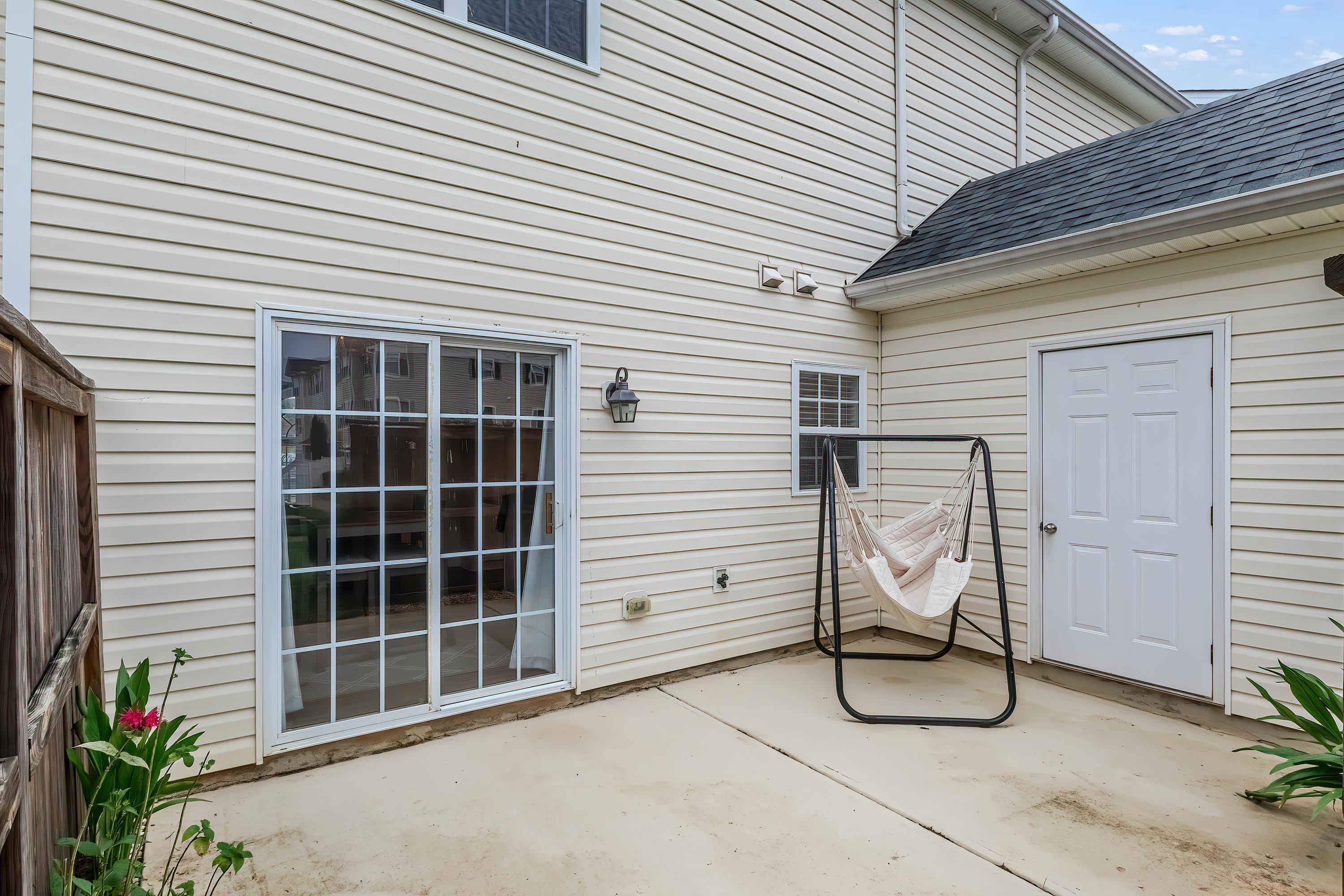 2131 Piney Brook Road, Unit 104 Raleigh, NC 27614 - Photo 34 of 37 a view of a patio with table and chairs and a barbeque