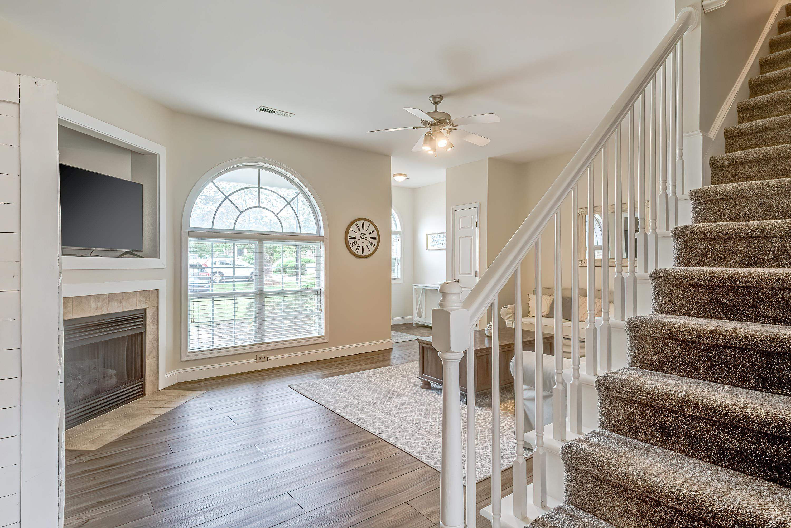 2131 Piney Brook Road, Unit 104 Raleigh, NC 27614 - Photo 10 of 37 a view of an entryway with wooden floor fireplace and a window