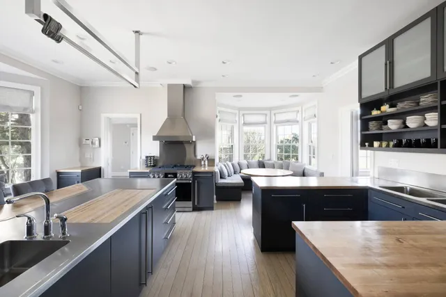 a kitchen with stainless steel appliances granite countertop sink stove top oven and cabinets