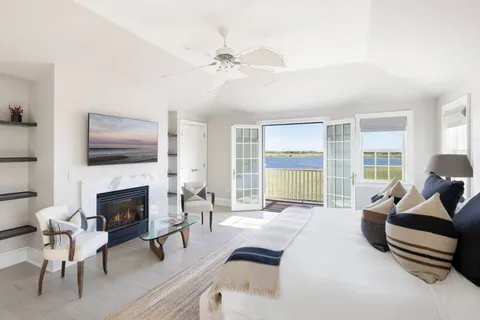 a living room with furniture fireplace and a large window