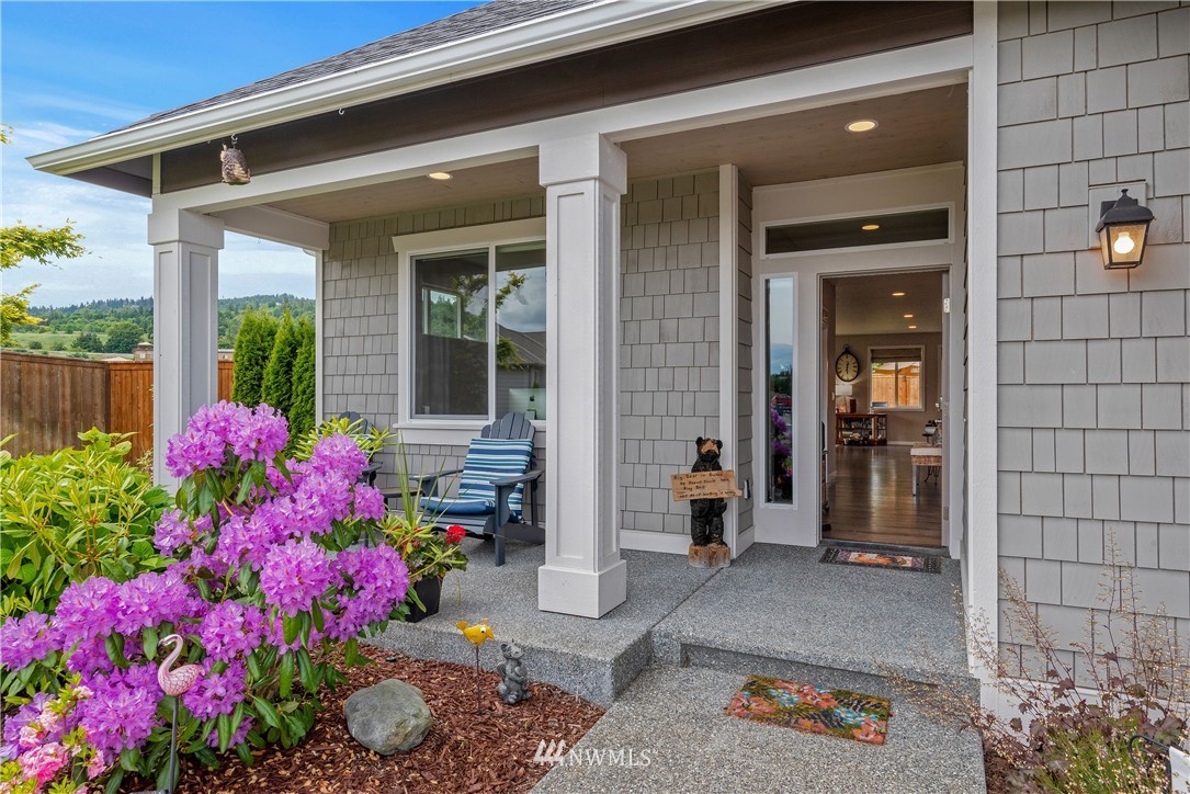 320 Blue Glacier Loop Sequim, WA 98382 - Photo 2 of 38 a view of a house that has a flower garden