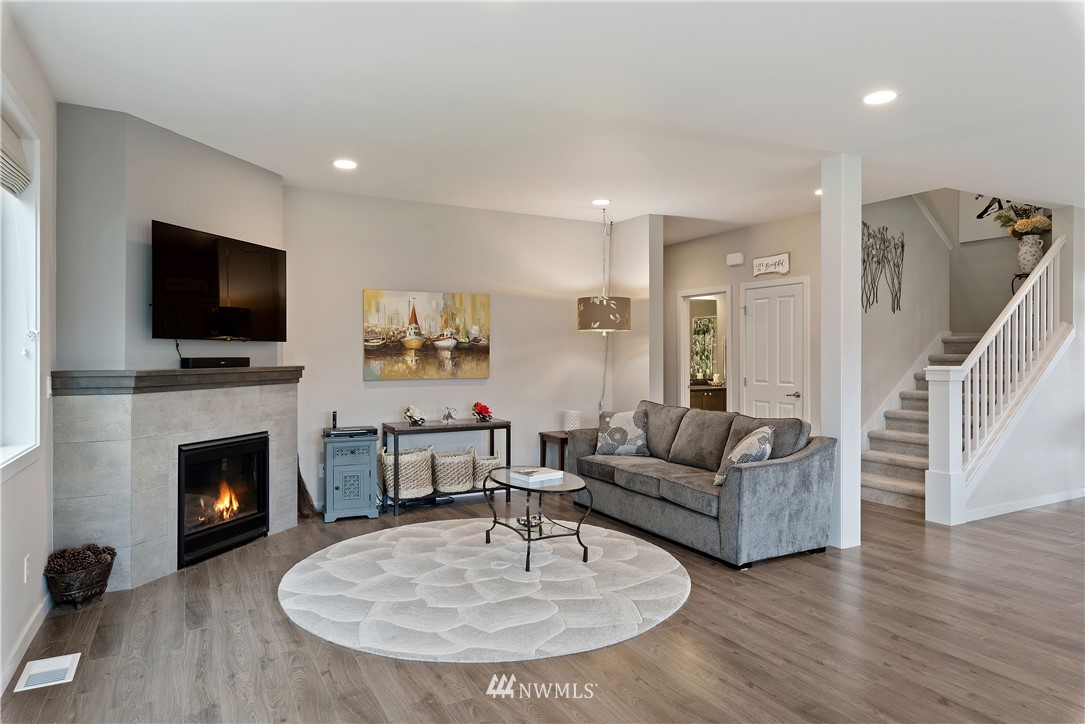 320 Blue Glacier Loop Sequim, WA 98382 - Photo 13 of 38 a living room with furniture a fireplace and a flat screen tv
