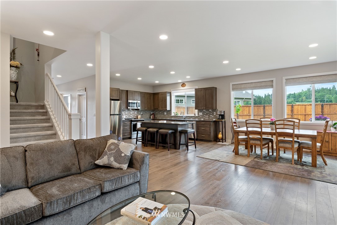 320 Blue Glacier Loop Sequim, WA 98382 - Photo 14 of 38 a living room with furniture kitchen view and a wooden floor
