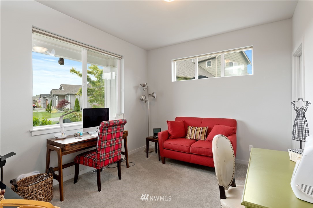 320 Blue Glacier Loop Sequim, WA 98382 - Photo 17 of 38 a living room with furniture a large window and a wooden floor