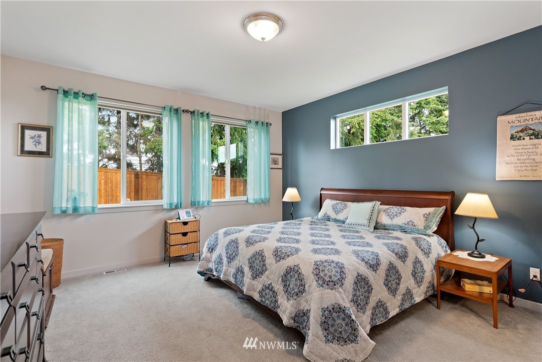 320 Blue Glacier Loop Sequim, WA 98382 - Photo 19 of 38 a bedroom with a bed and a lamp with window